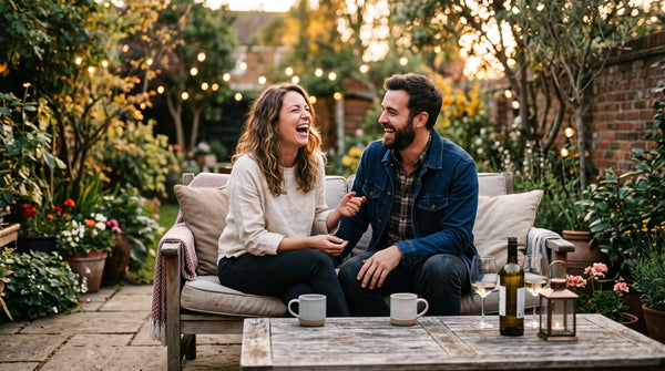 Couple sitting outdoors laughing together in a relaxed moment